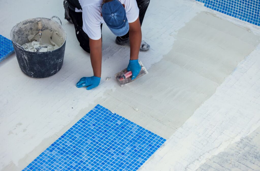 Technician from Alotta Pool Service repairing pool equipment in Lee County, FL, ensuring proper functionality.