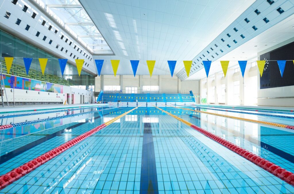 Alotta Pool Service crew working on a large commercial pool in Estero, FL, emphasizing local expertise and advantages